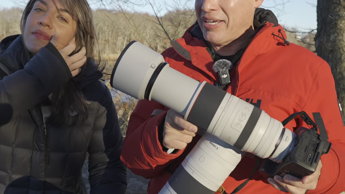 Tony holding the Canon 200-800mm lens outdoors in cold weather