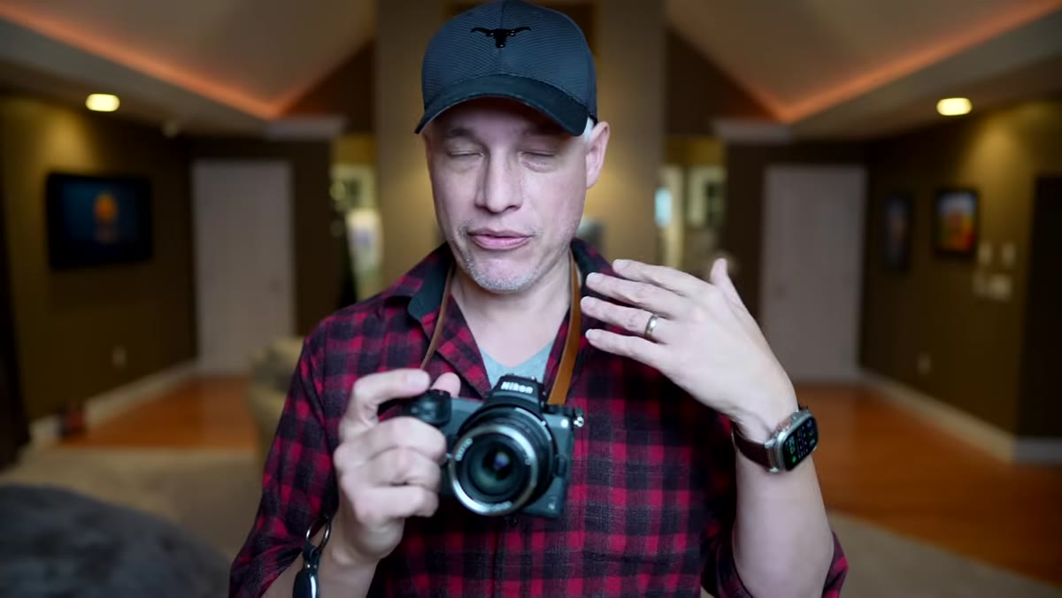 Photographer shooting handheld with camera around neck