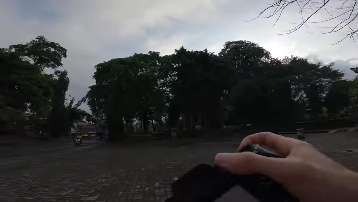 Pierre raising camera toward busy main road scene