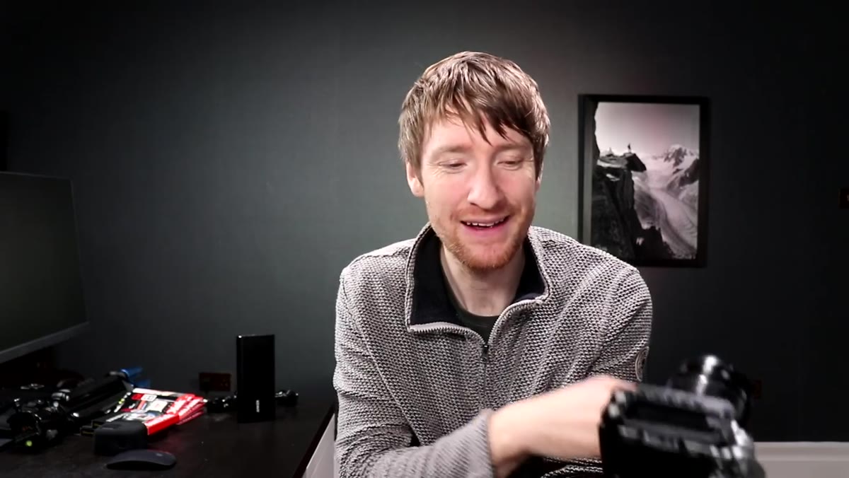 Heaton holding multiple Fujifilm batteries, discussing battery drain