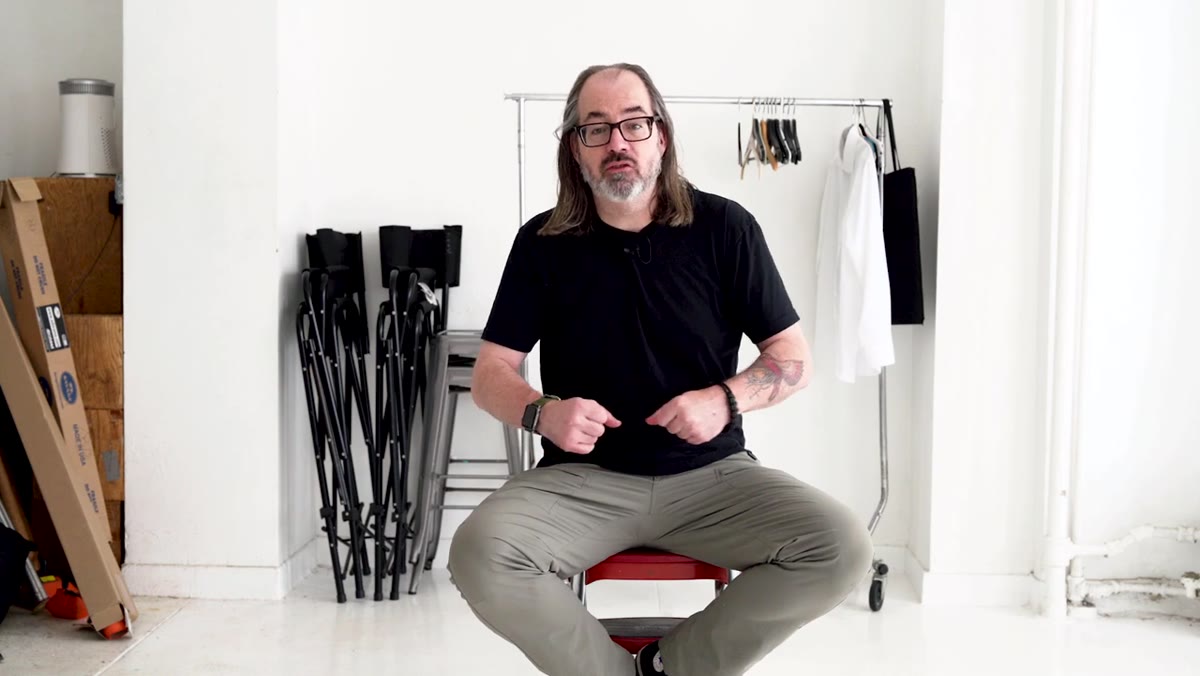 Daniel referencing his video kit in a Pelican-style case with cables and chargers
