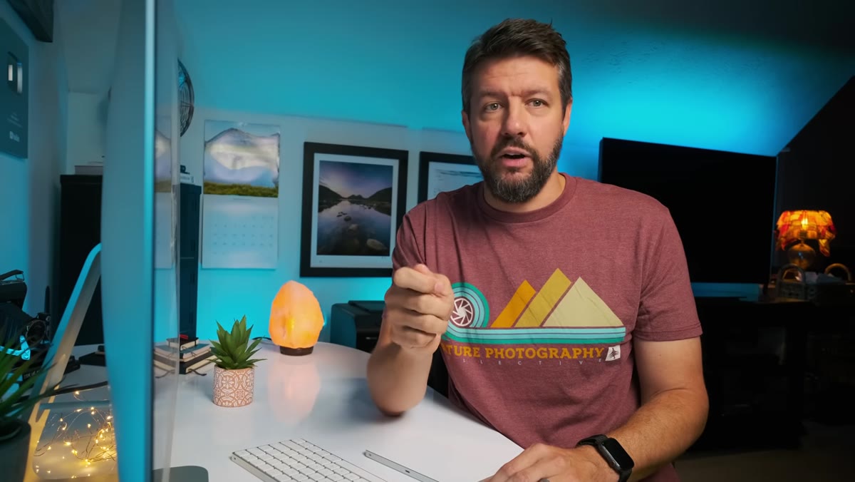 Photographer at location choosing between wide and long lens