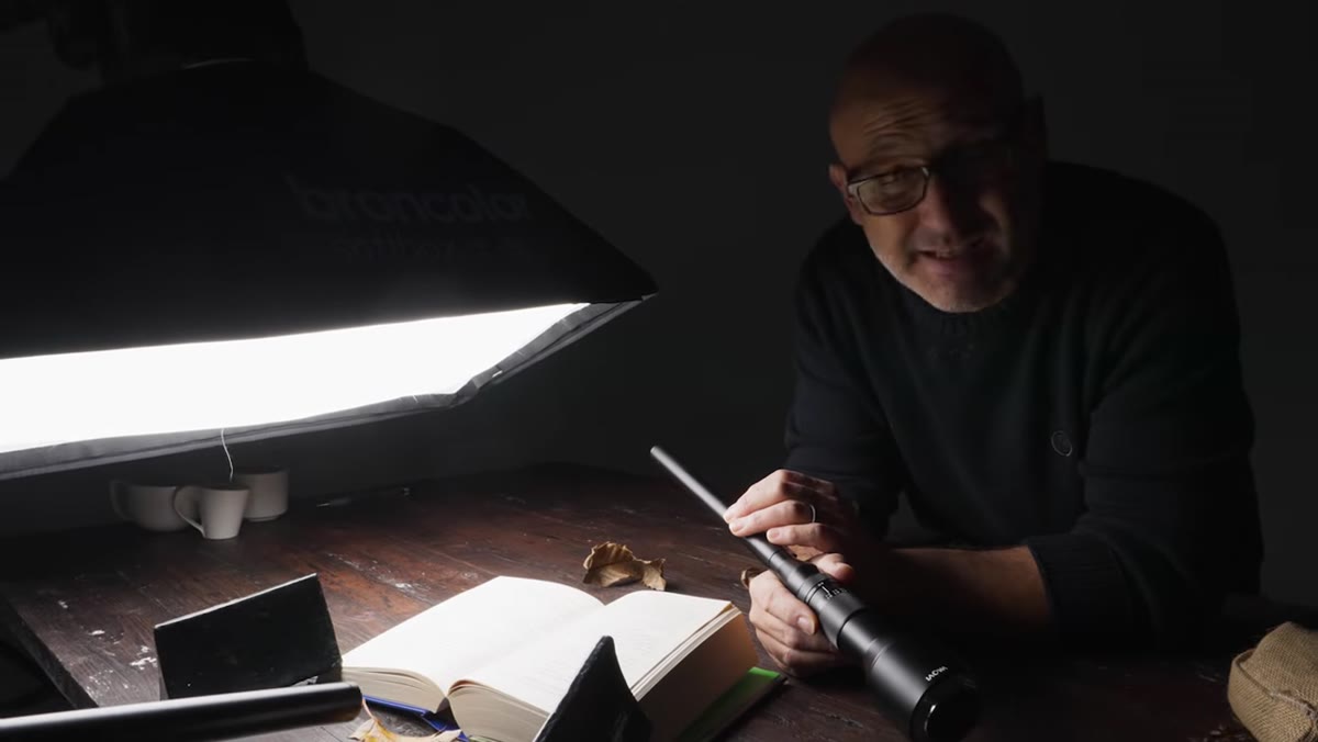 Setup showing probe lens scanning across open book for sharpness test