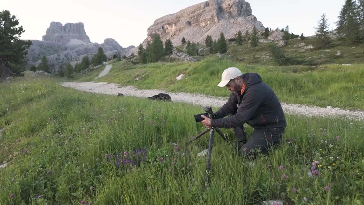 Shooting at 400mm toward sun cresting distant mountain peak
