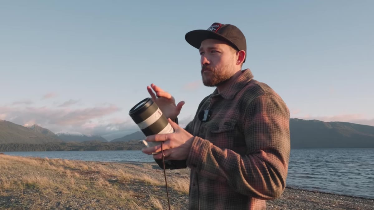 Patino scanning the mountain range with camera raised