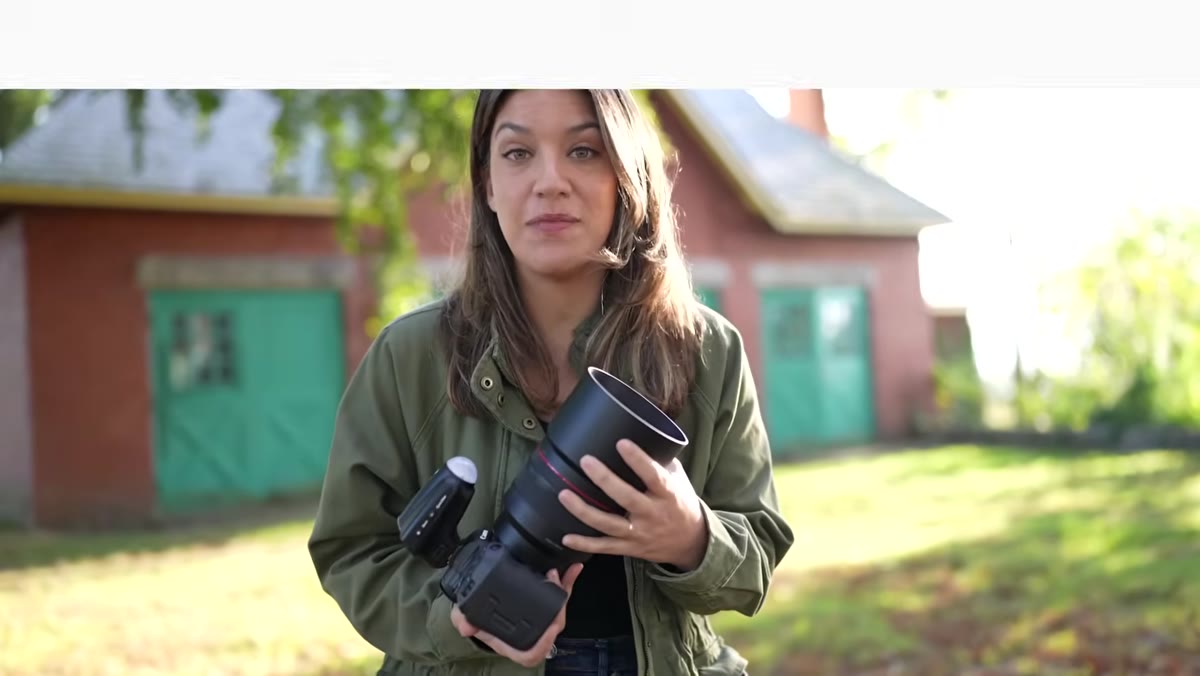 Chelsea holding a large 85mm f/1.2 prime lens
