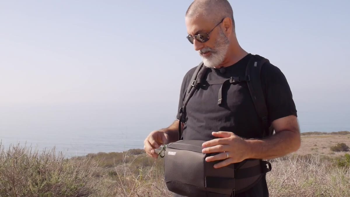 Camera compartment rotated to front, open and accessible while worn