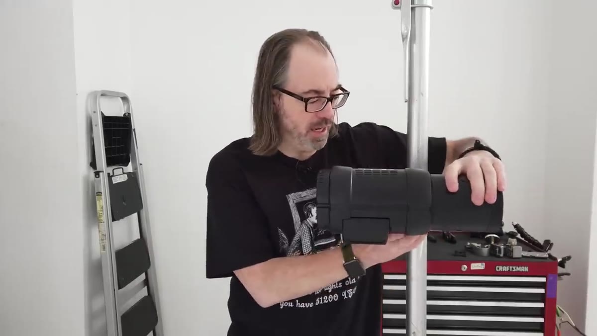 Photographer adjusting and rotating light position on the mounted clamp