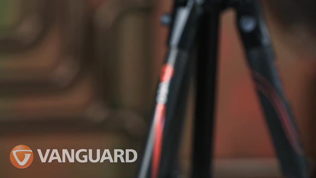 Carbon fiber legs shown close-up while tripod is held in one hand