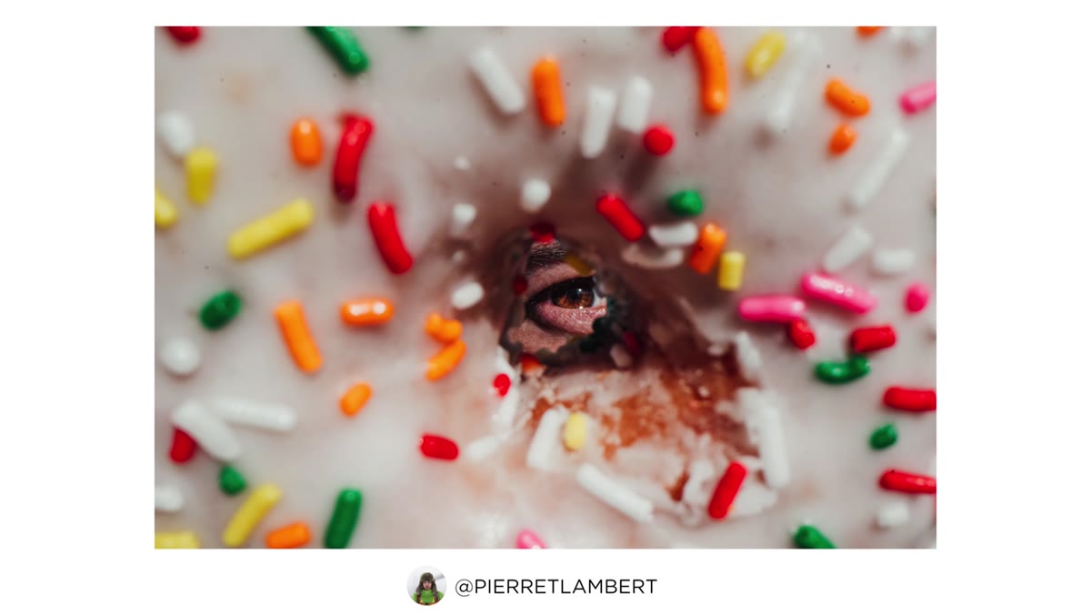 Pierre positioning the donut in front of Joey&rsquo;s eye for close portrait