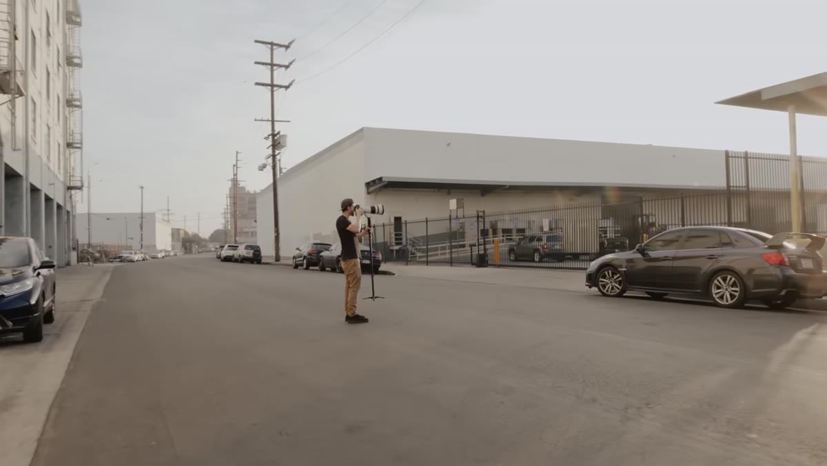 Photographer calling out specific position adjustments to standing male model