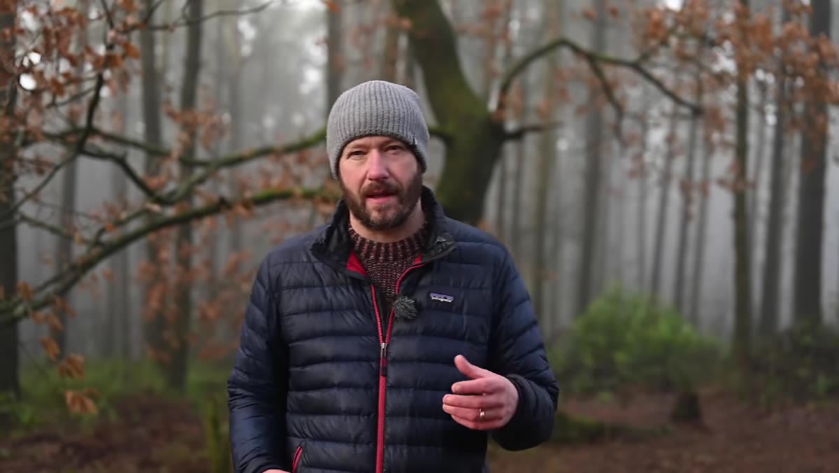 Danson walking a trail and describing bad-weather lens-change problems