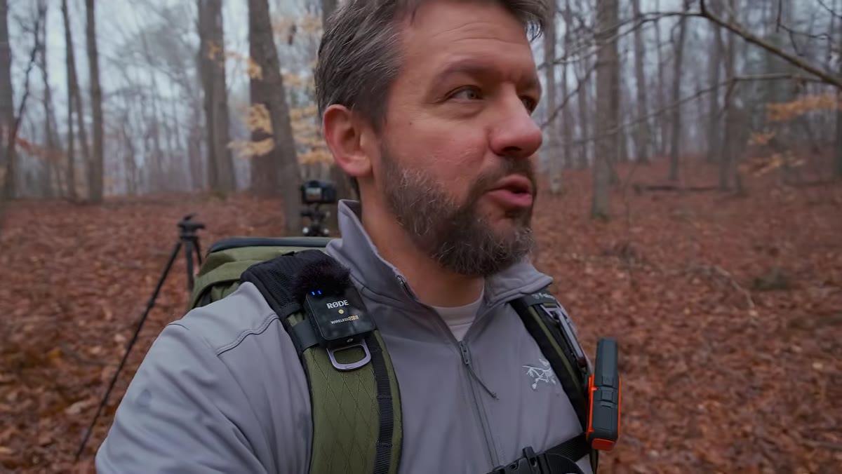 Fog visibly thinning above tree line while Denney continues shooting