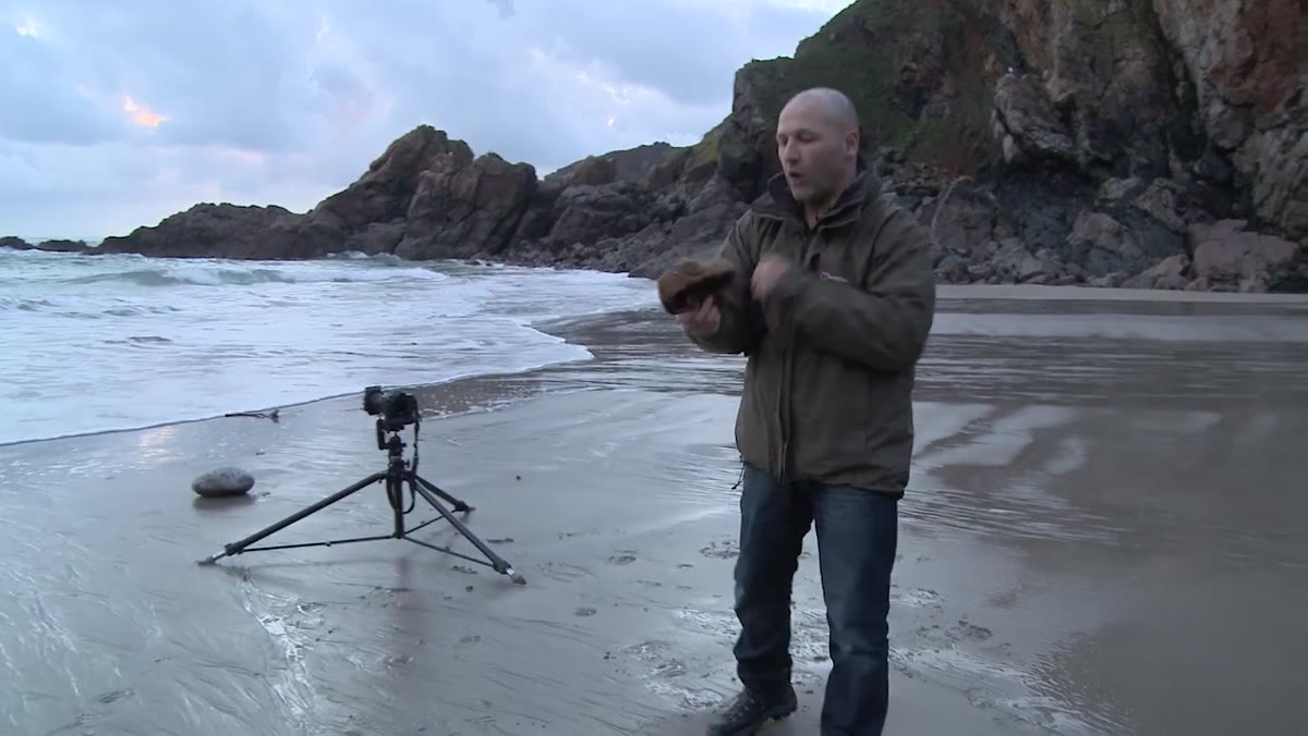 Photographer pausing mid-shoot to address the camera about cold