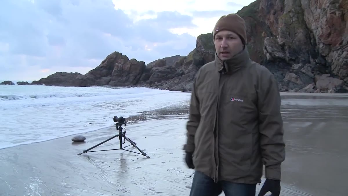 Photographer referencing layers worn beneath outer jacket